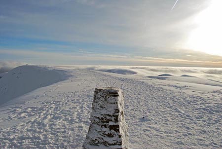 Trig point on Helvellyn with temperature inversion behind